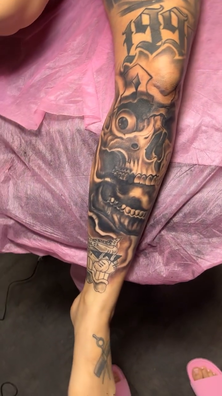 Skull and smoke leg sleeve realism tattoo on the leg by Yulia Chekir, Chicago, Illinois