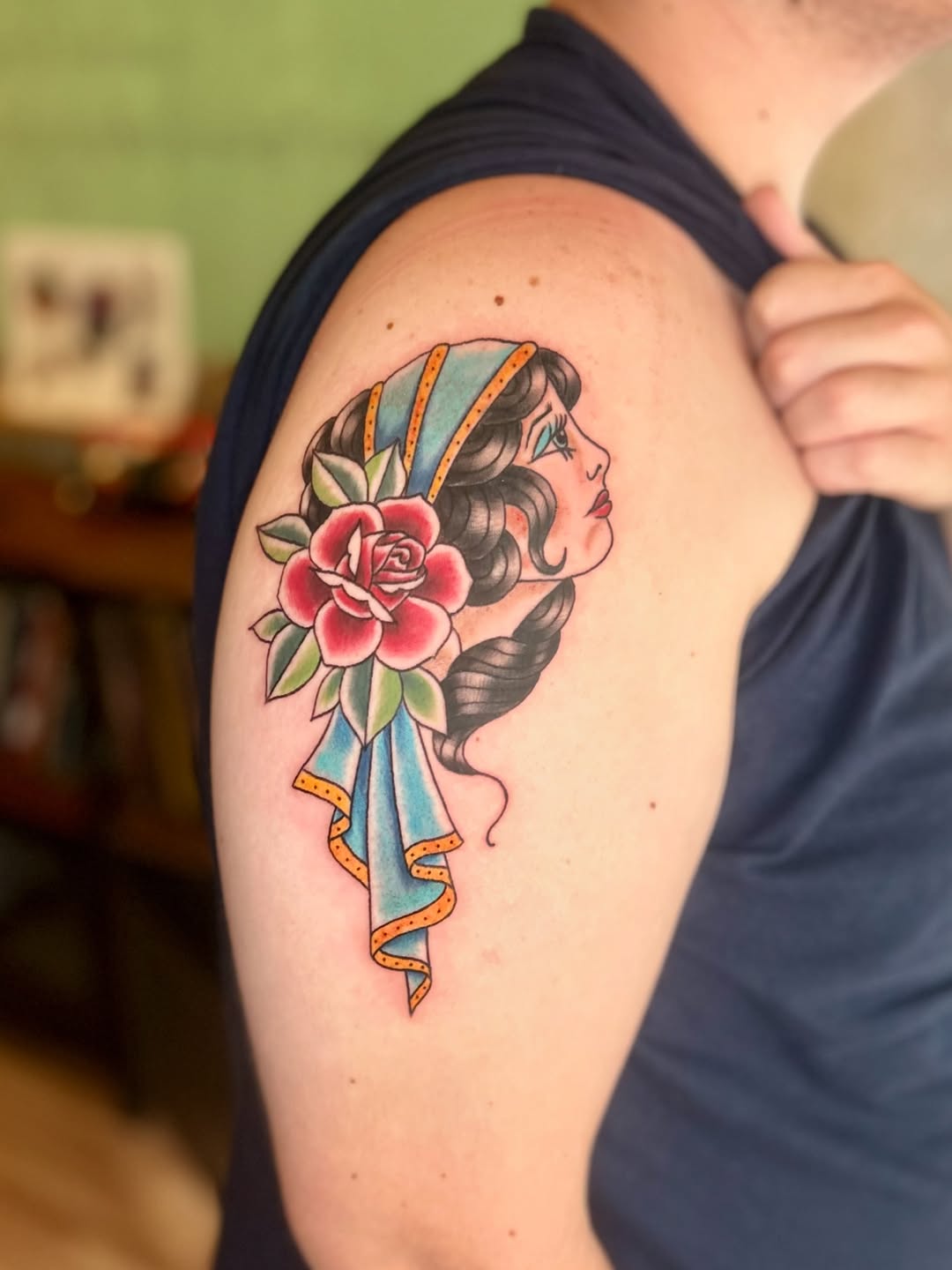 Woman with rose neo-traditional tattoo on the shoulder by Tori Magill