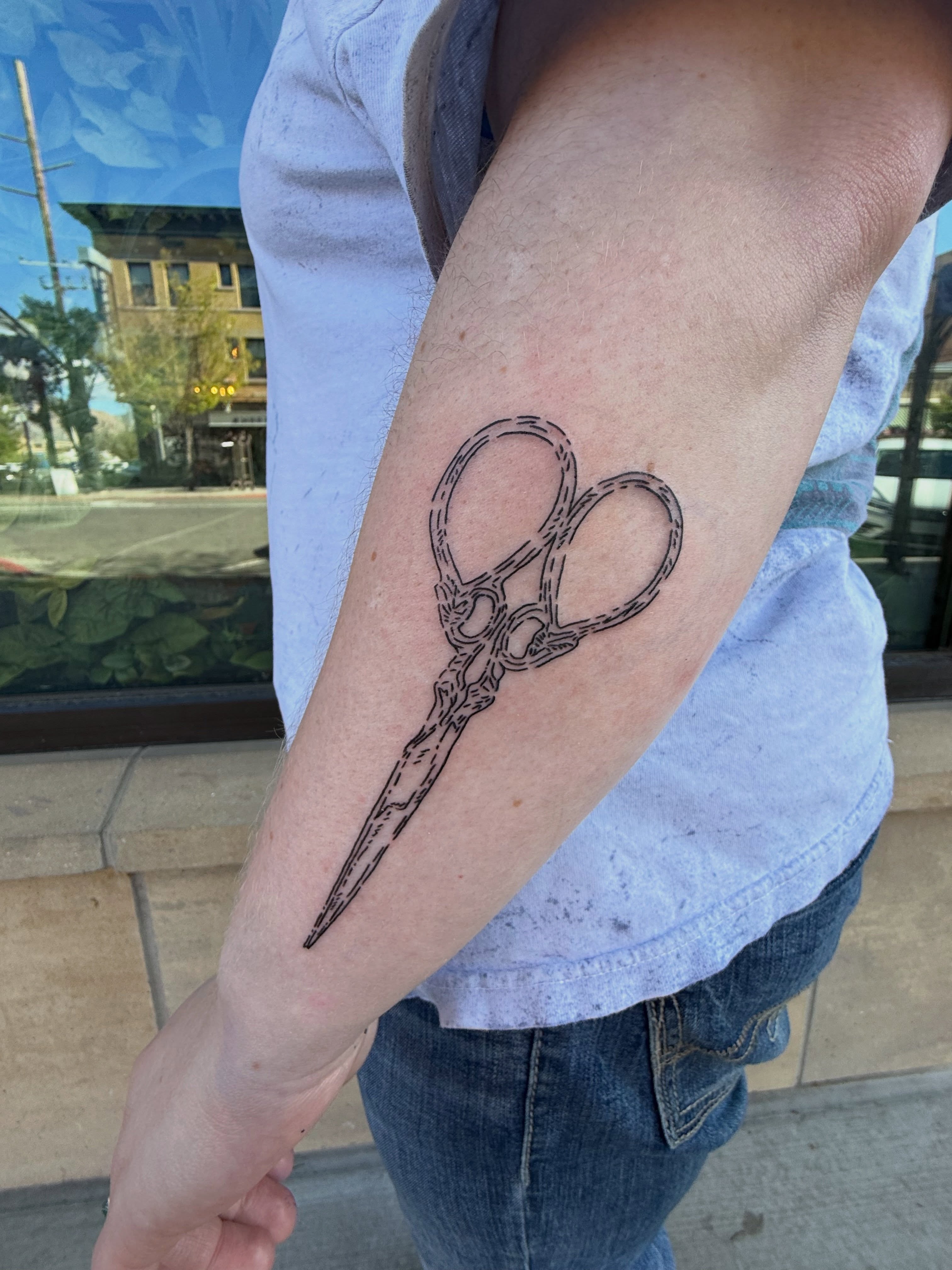 Scissors black and grey tattoo on the forearm by Kieara West