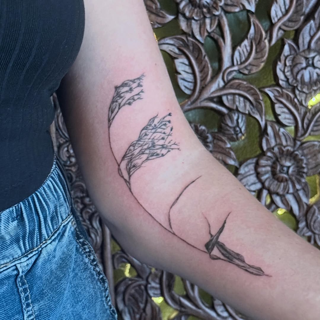 Grass fine line tattoo on the forearm by Emily Rose Lumsdaine