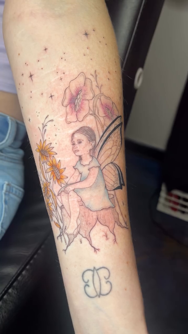 Fairy with flowers fine line tattoo on the forearm by Sid
