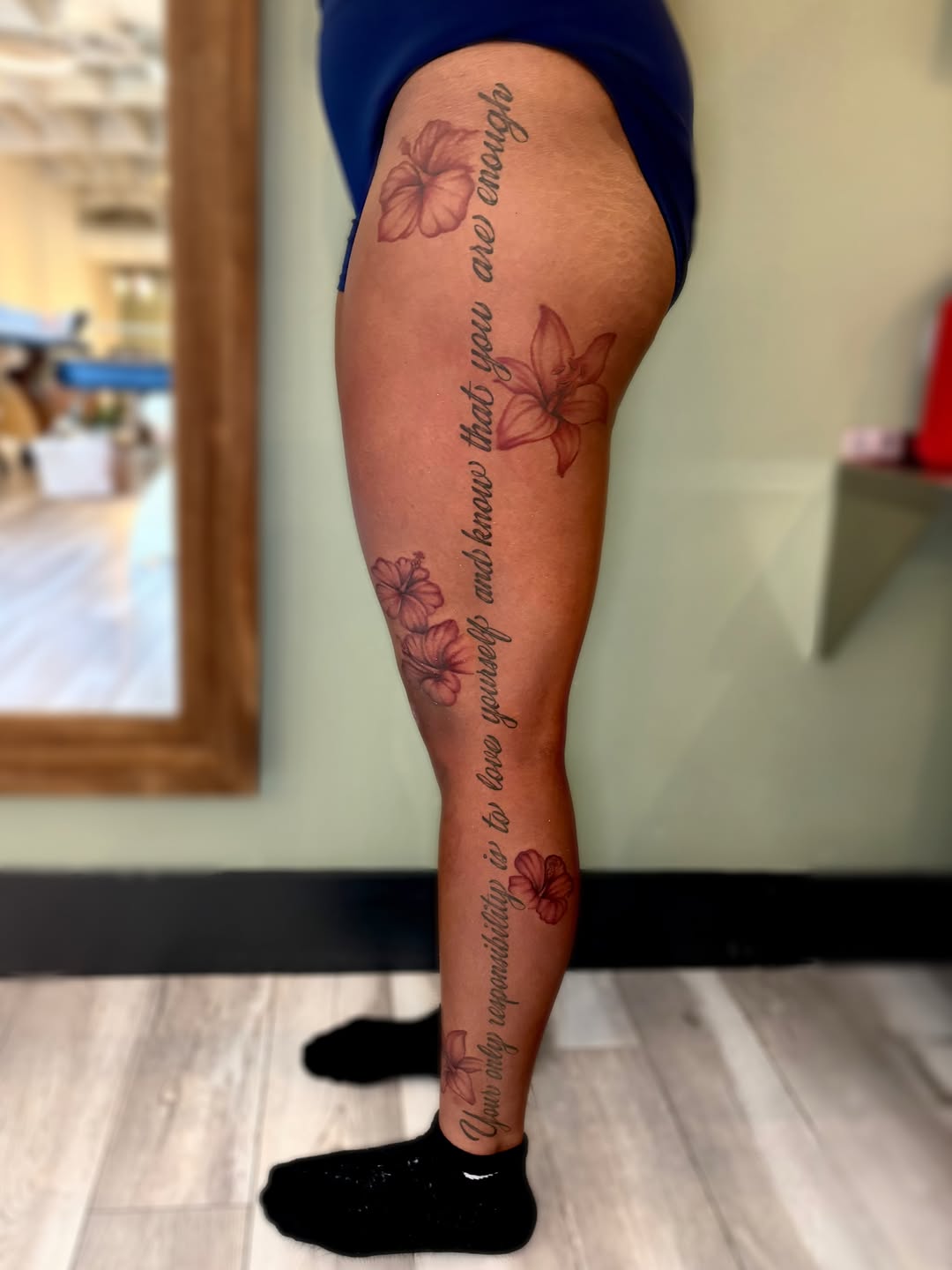 Script with flowers neo-traditional tattoo on the calf by Bianca Cattapan