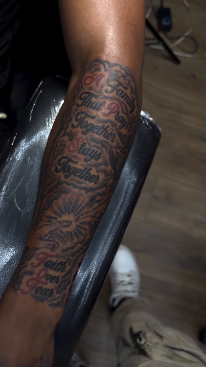 Family and faith text tattoo Chicano tattoo on the forearm by Mike Tatts