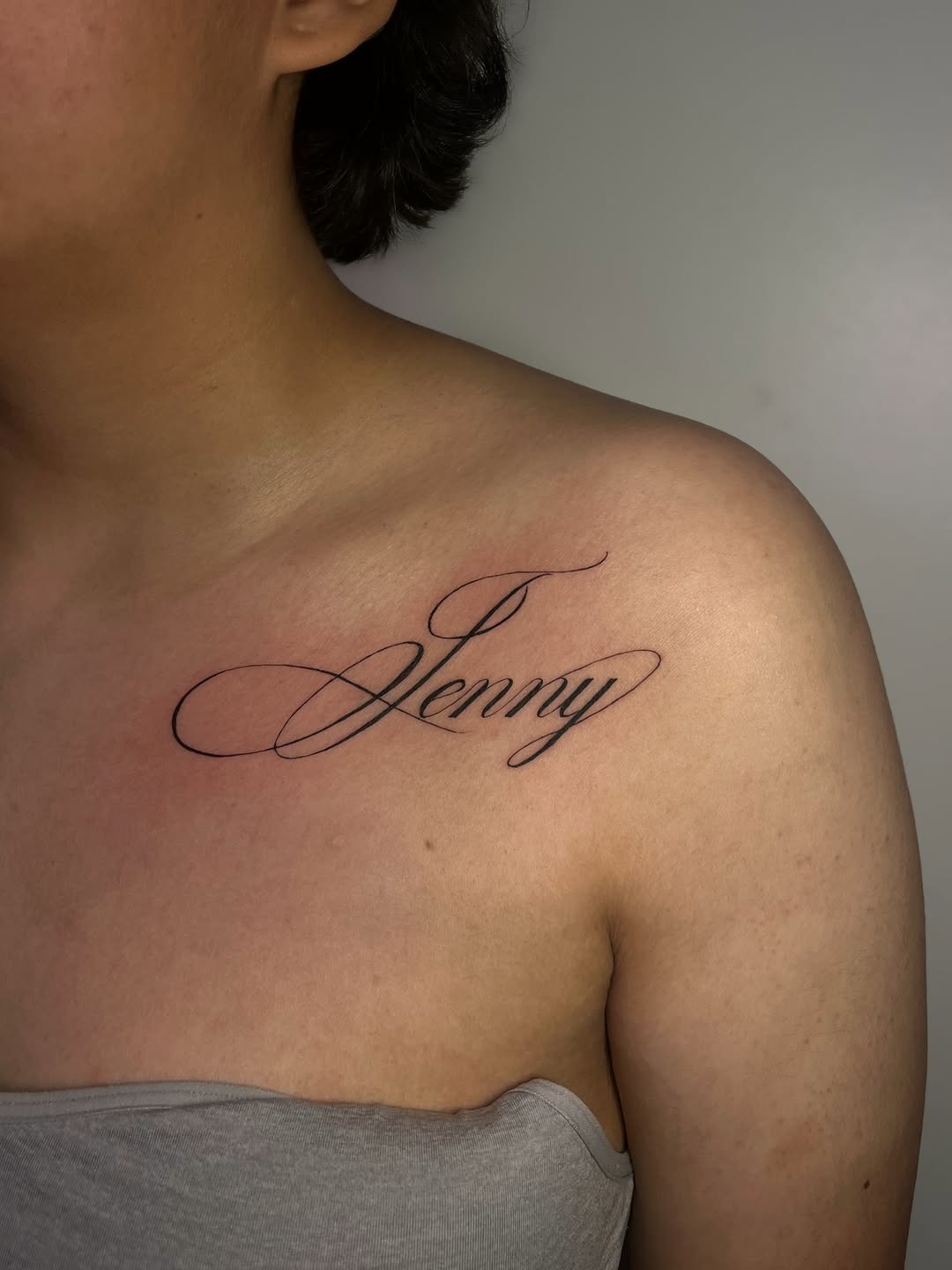 Script lettering lettering tattoo on the chest by MK