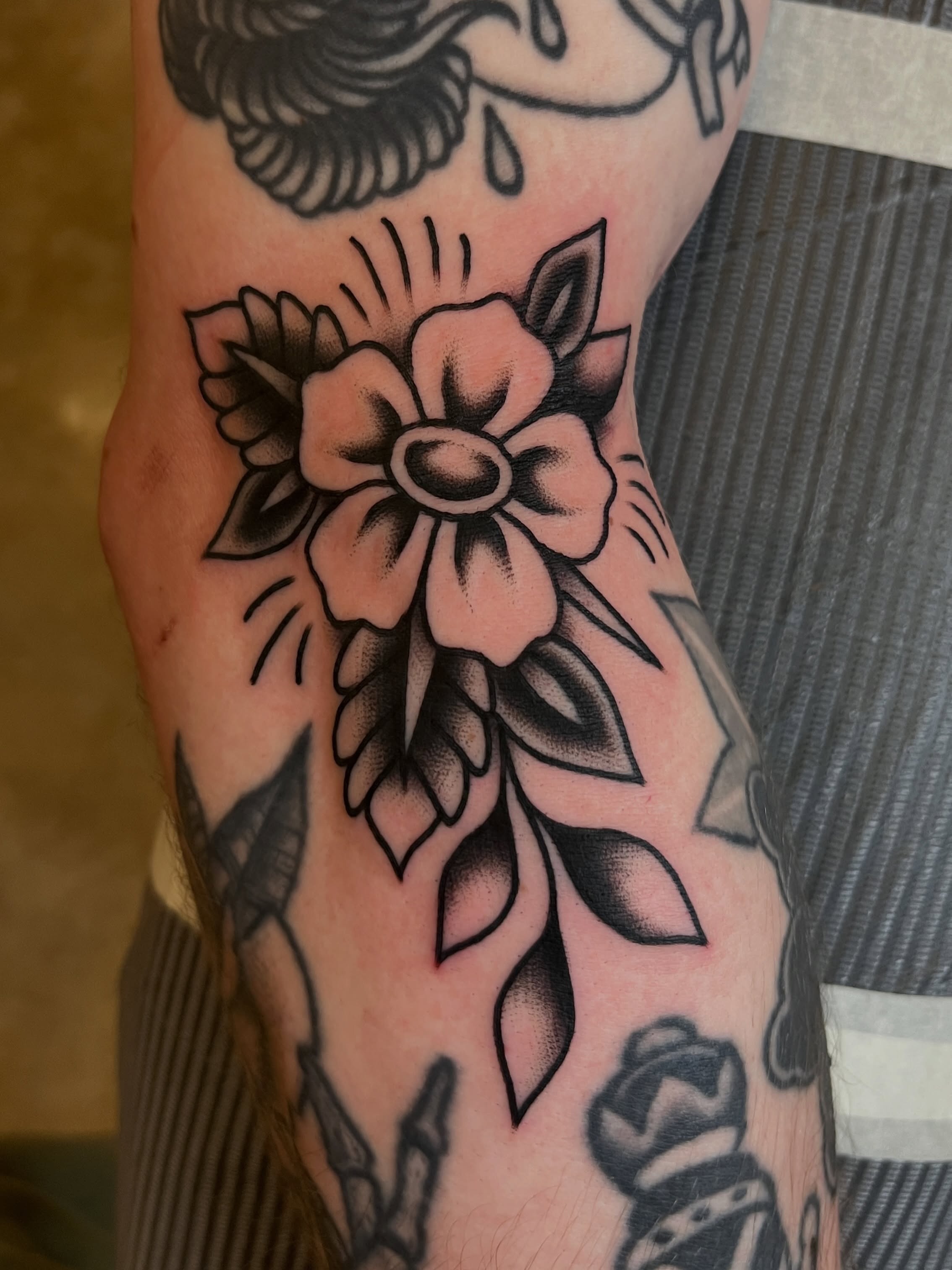 Flower American traditional tattoo on the forearm by Anthony Tattooer, Seattle, Washington