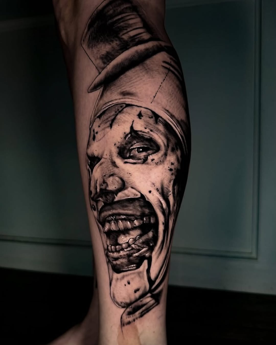 Creepy clown face realism tattoo on the forearm by Brooke Kresco