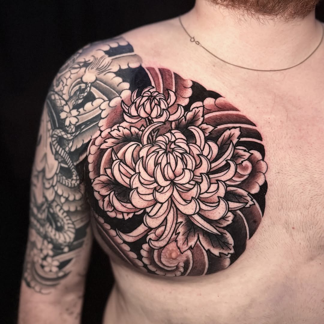 Chrysanthemum and waves Japanese tattoo on the chest by Matt Trimble, Charlotte, North Carolina