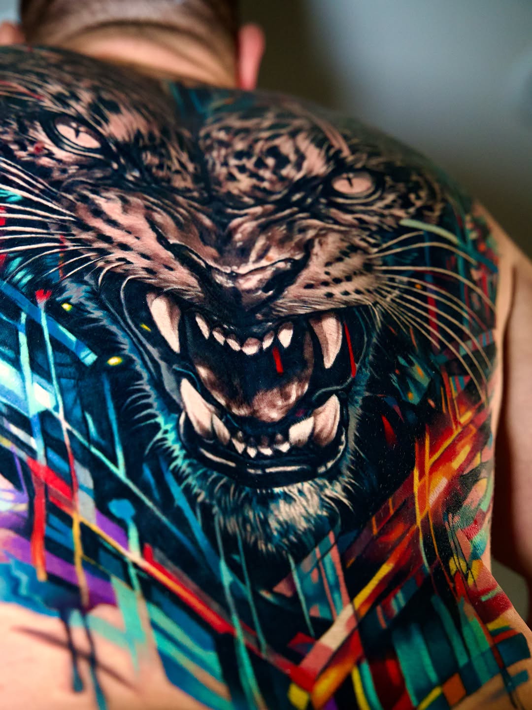 Tiger face with abstract background watercolor tattoo on the back by Israel De Jesus Legonier Aguliera