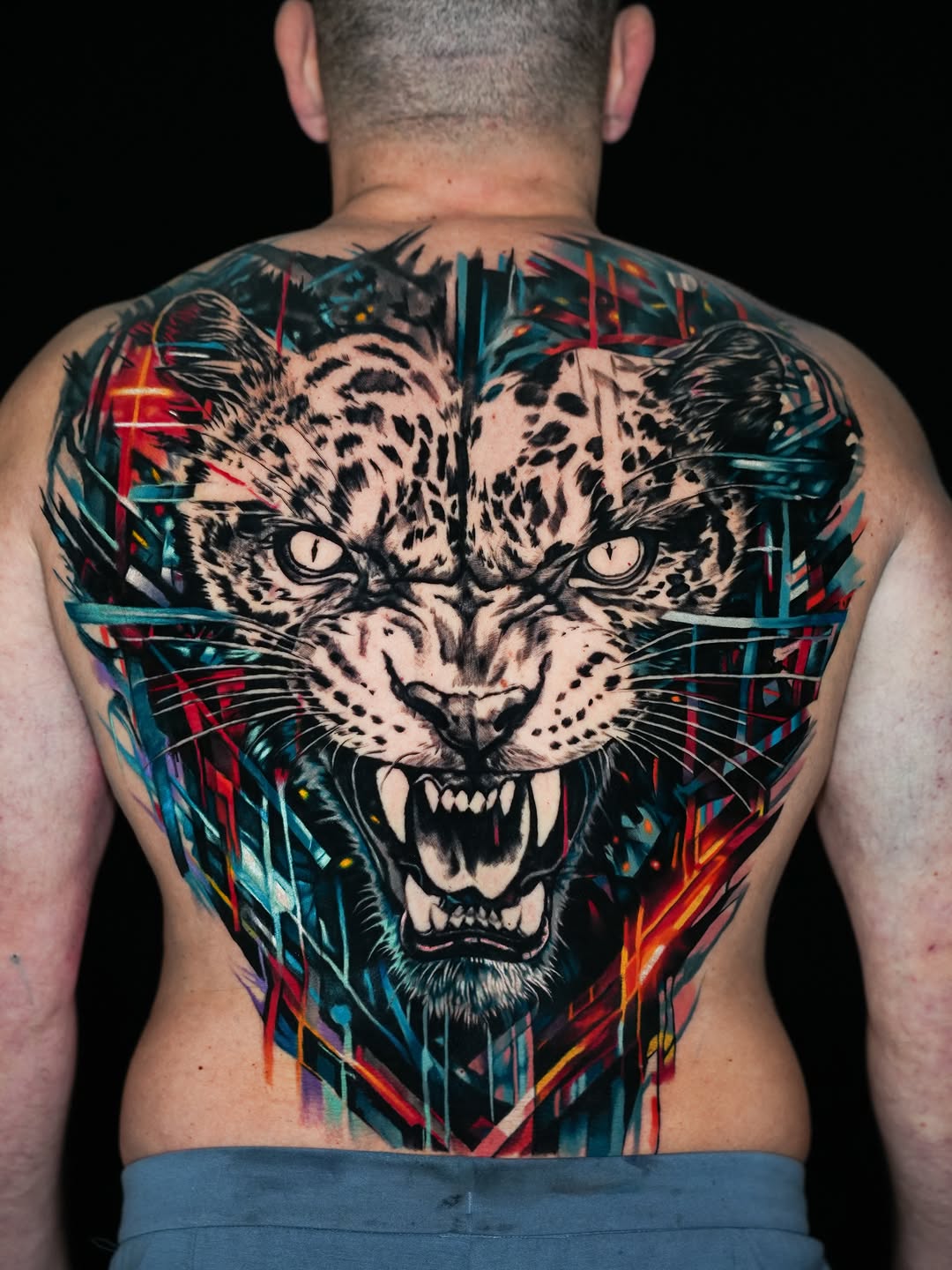 Jaguar face realism tattoo on the back by Israel De Jesus Legonier Aguliera