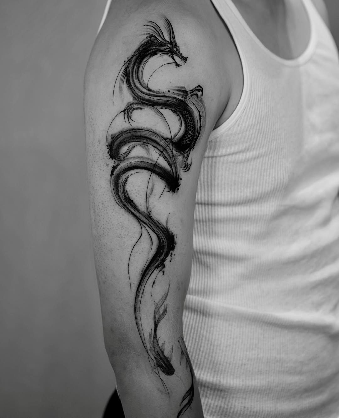 Dragon dotwork tattoo on the upper arm by Damon_modoink