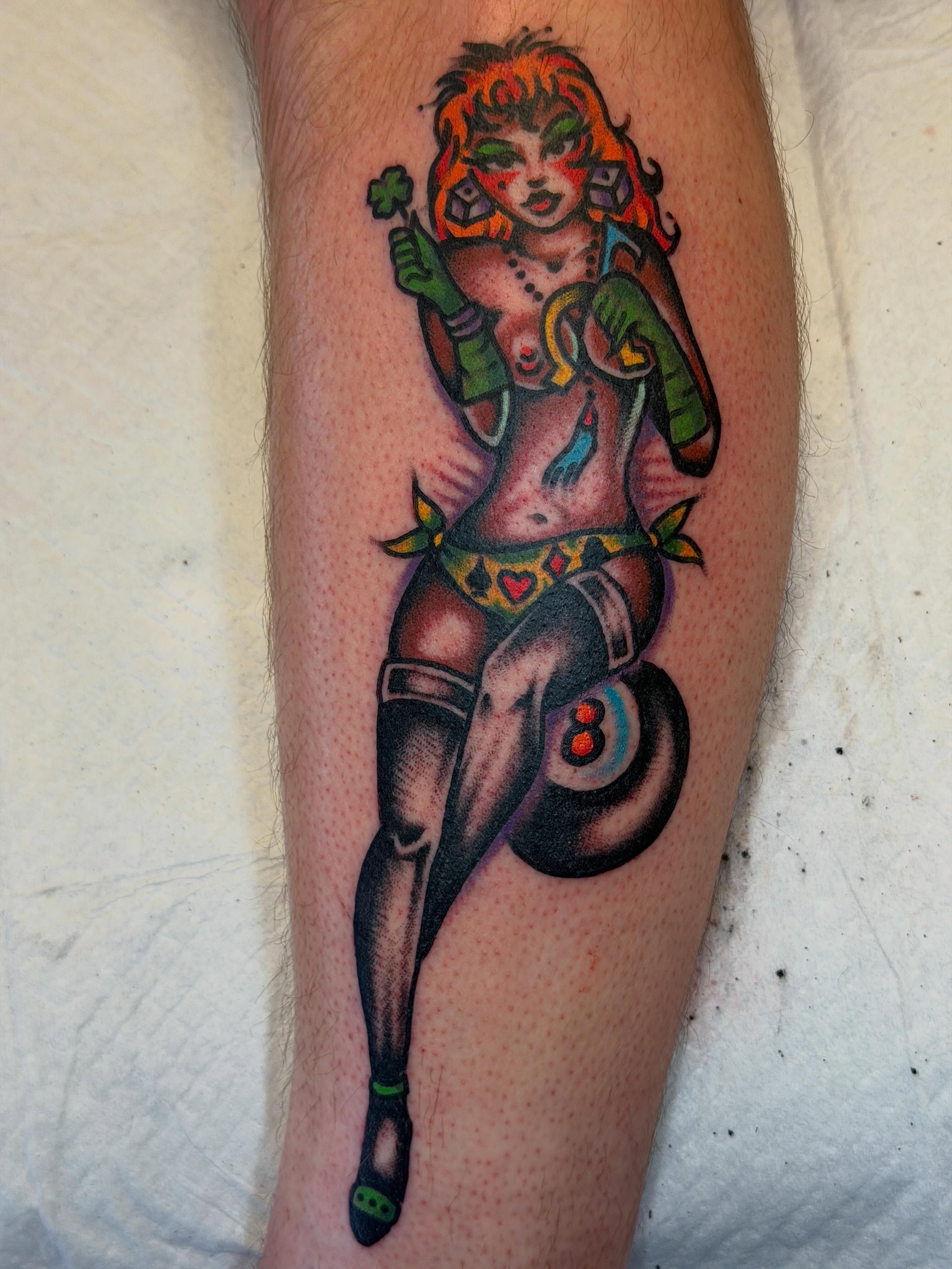 Pin-up girl American traditional tattoo on the thigh by Joshua Speight