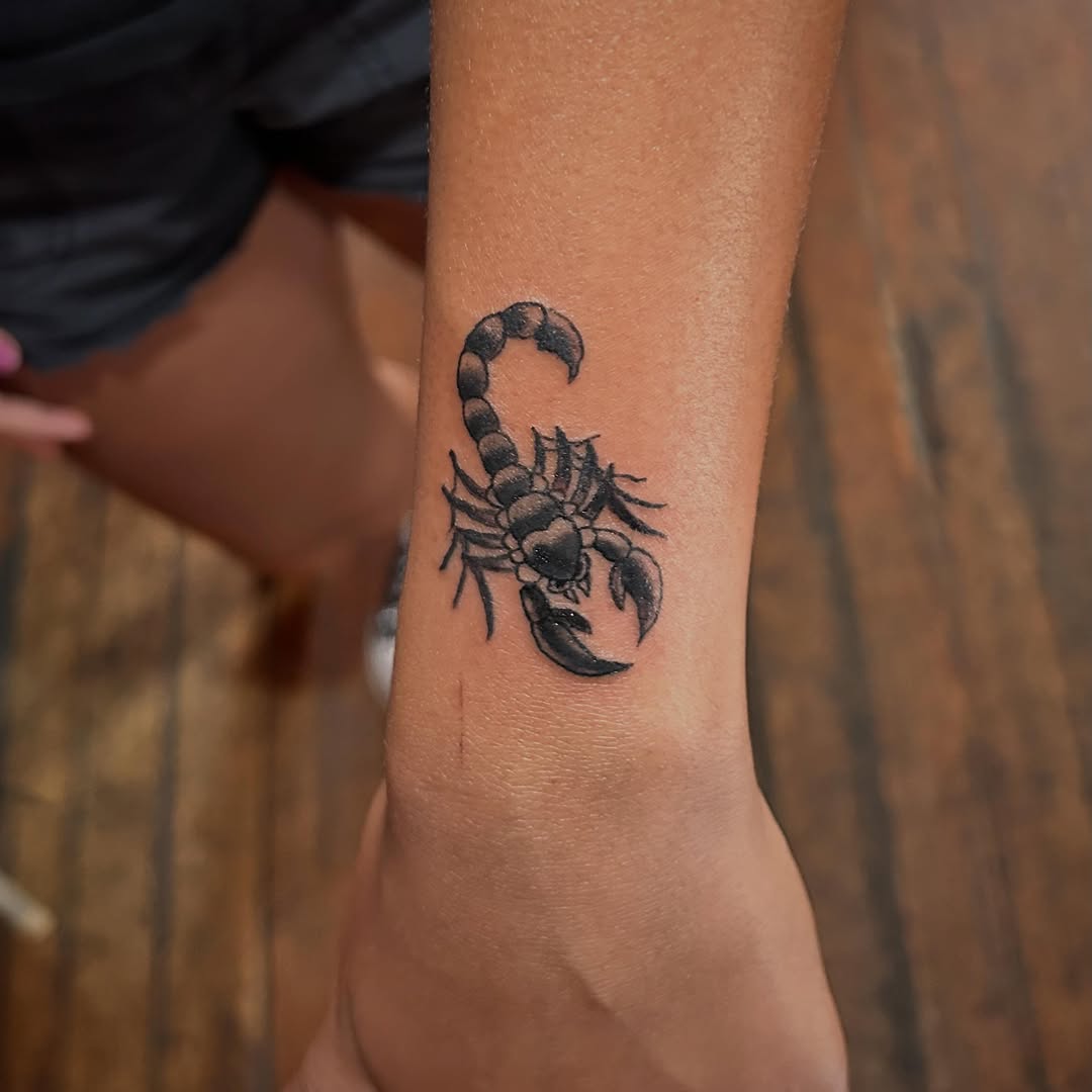 Scorpion fine line tattoo on the forearm by Miss Katie