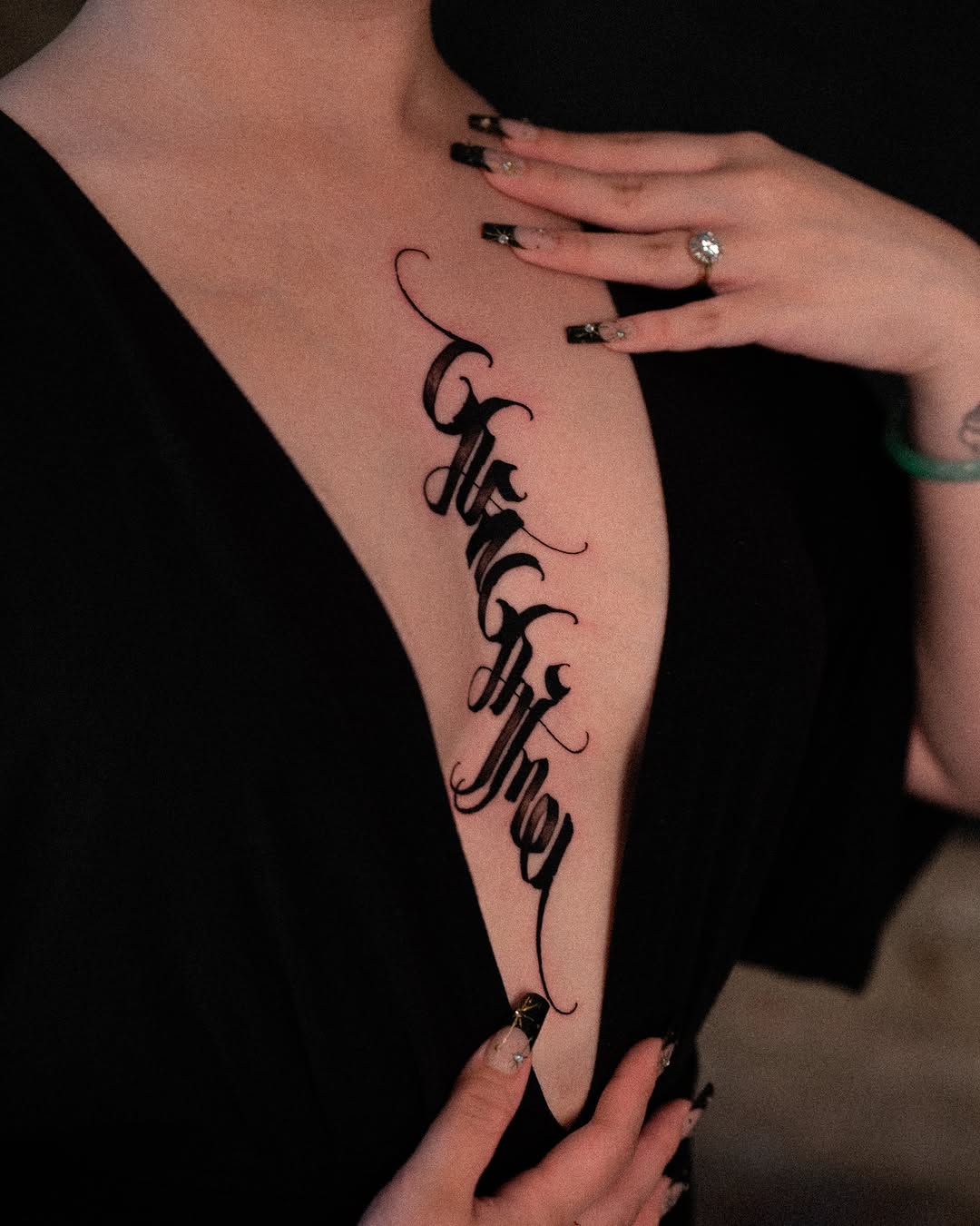 Calligraphy lettering Chicano tattoo on the chest by Low, Brooklyn, New York