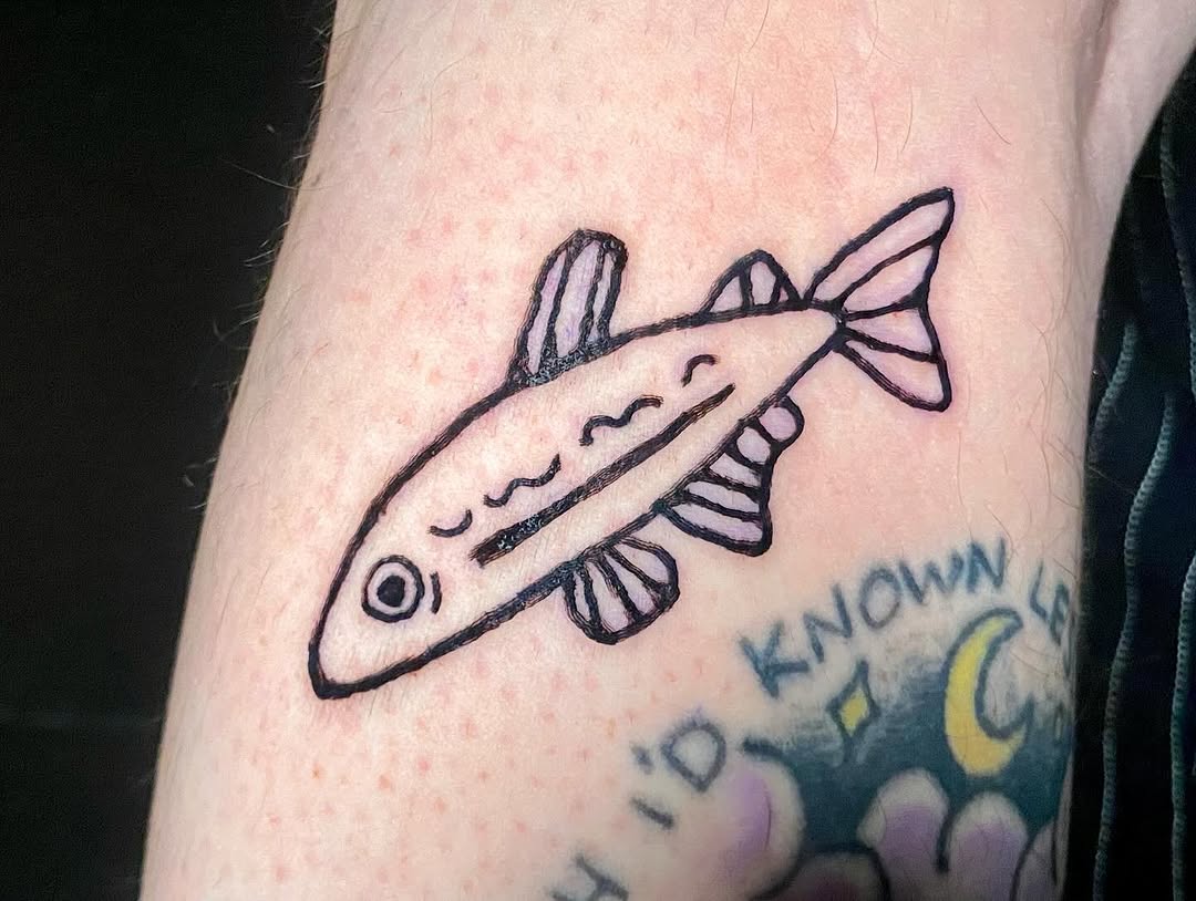 Simple fish fine line tattoo on the forearm by ollie, Portland, Oregon
