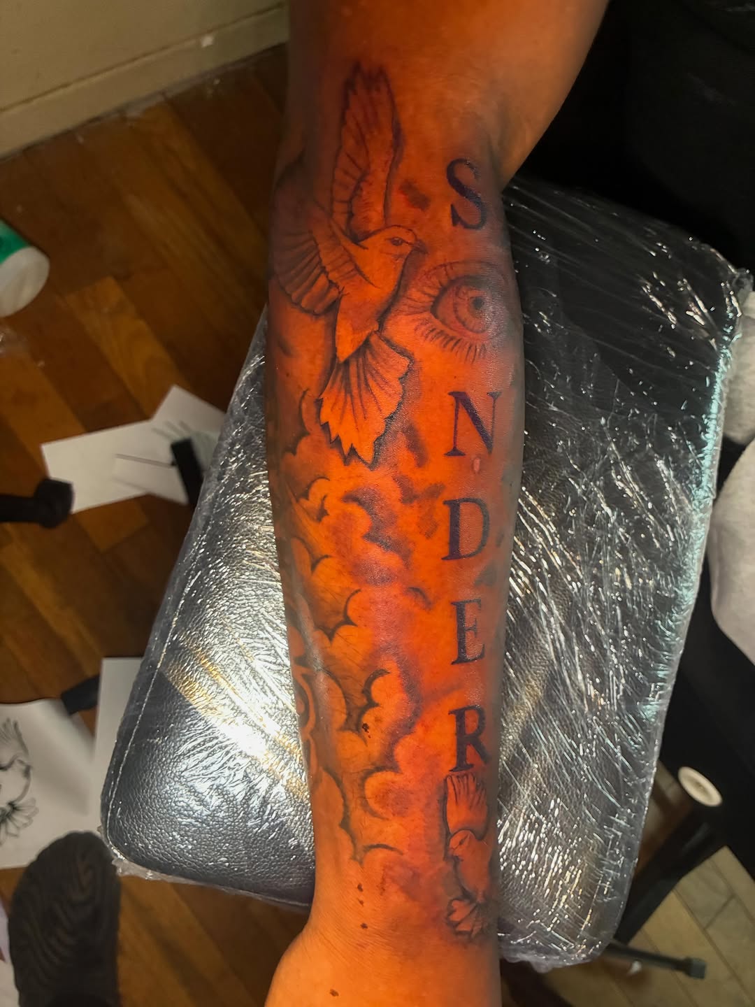 Dove and eye with lettering tattoo on the forearm by Detroit tattoo Artist