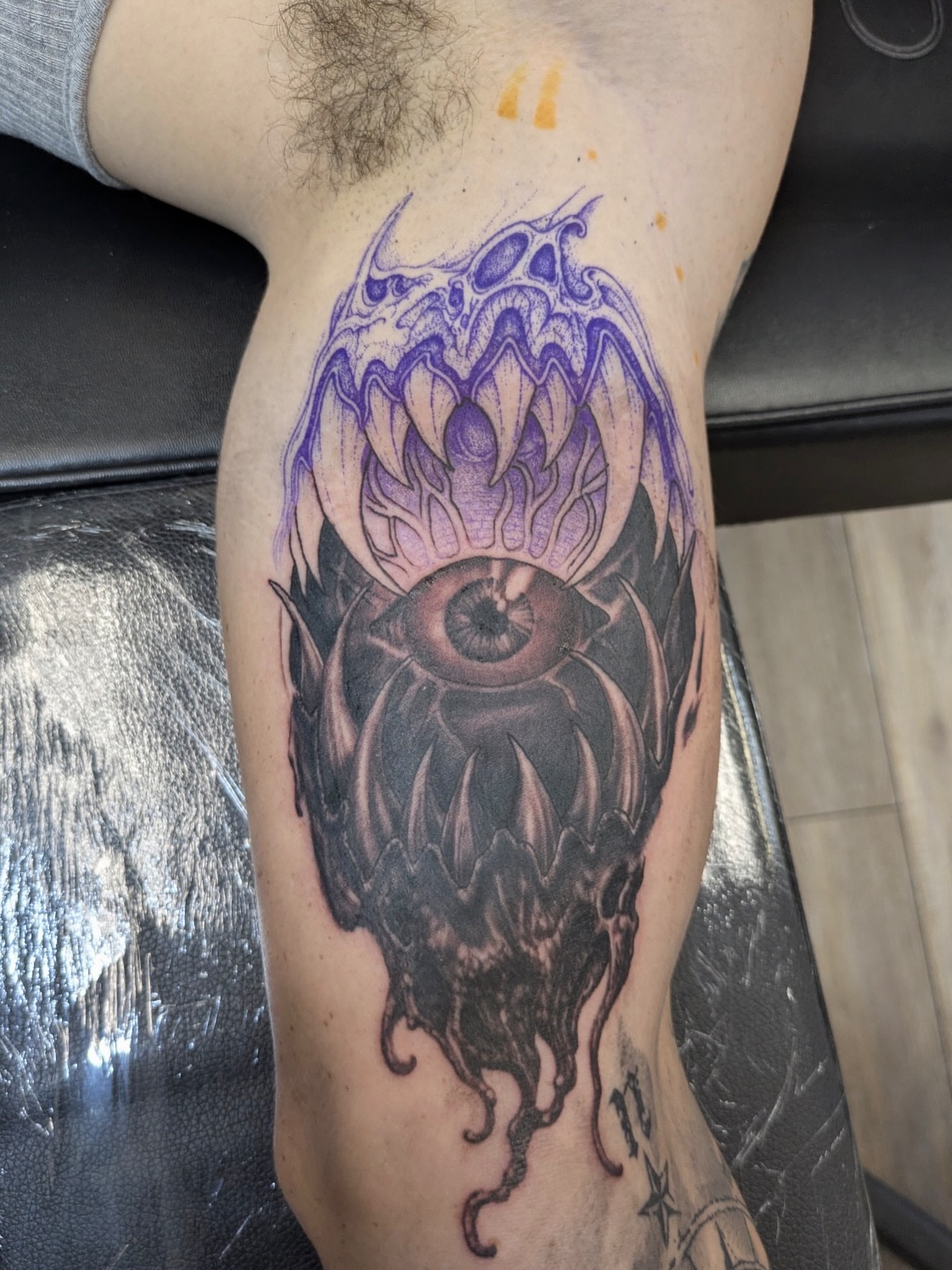 Eye and lotus dark realism tattoo on the forearm by Buddy K.