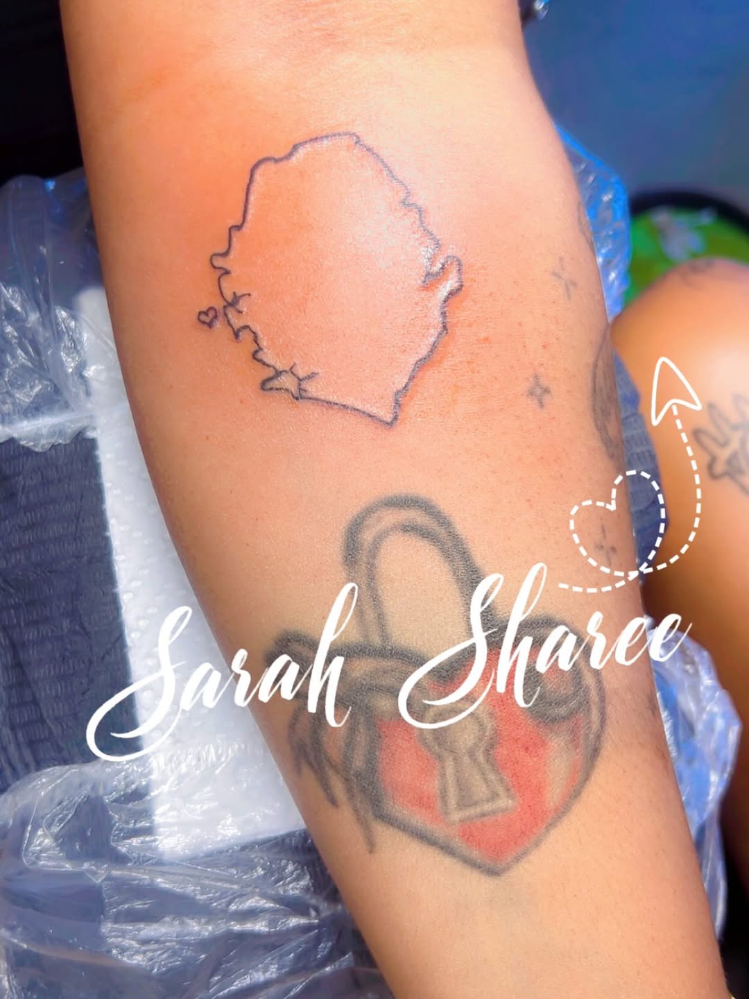 Map outline with small heart tattoo on the forearm by Sarah Sharee💃🏽