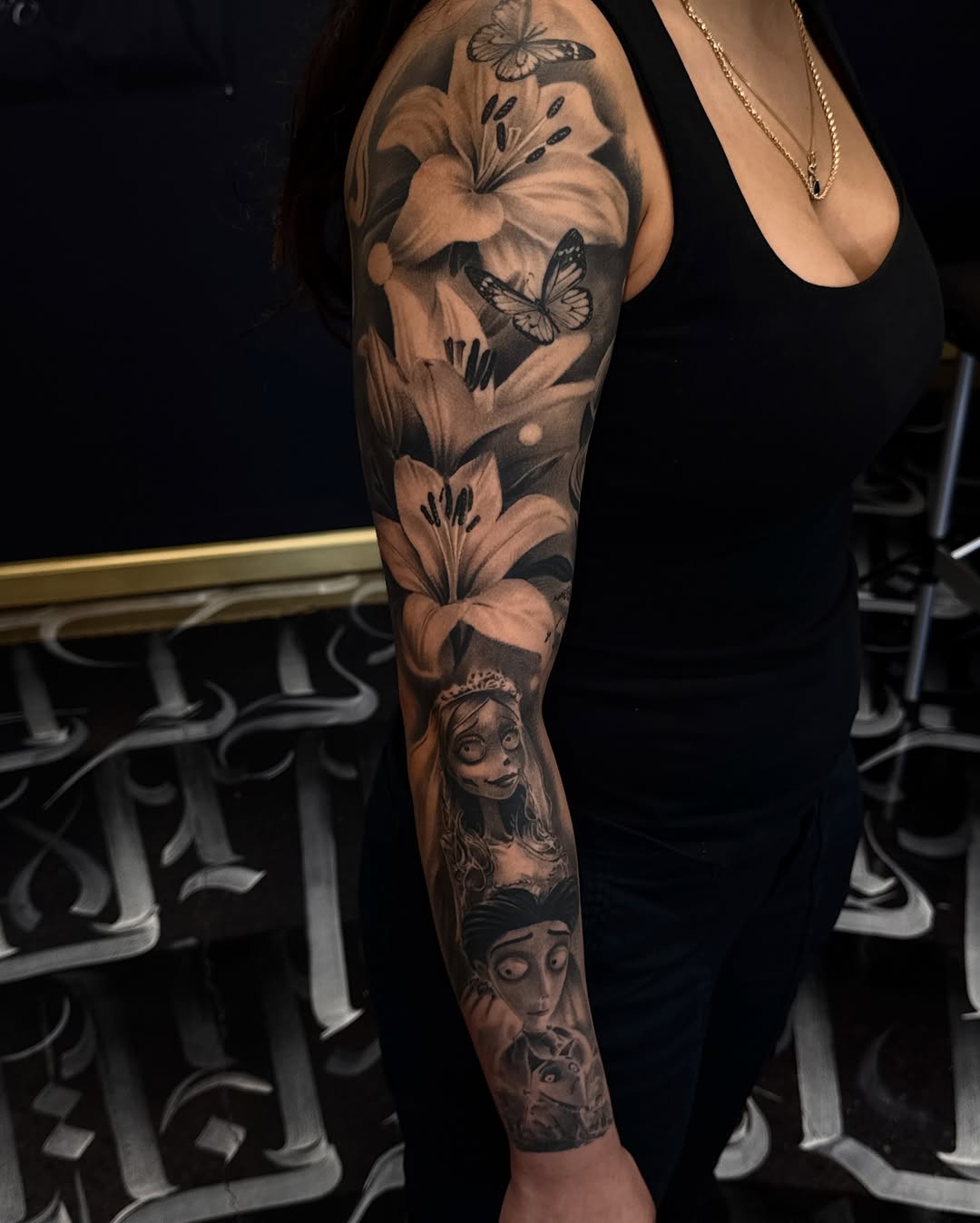 Corpse Bride characters and lilies realism tattoo on the forearm by Gee Lagunas 🇲🇽, Springfield, Virginia