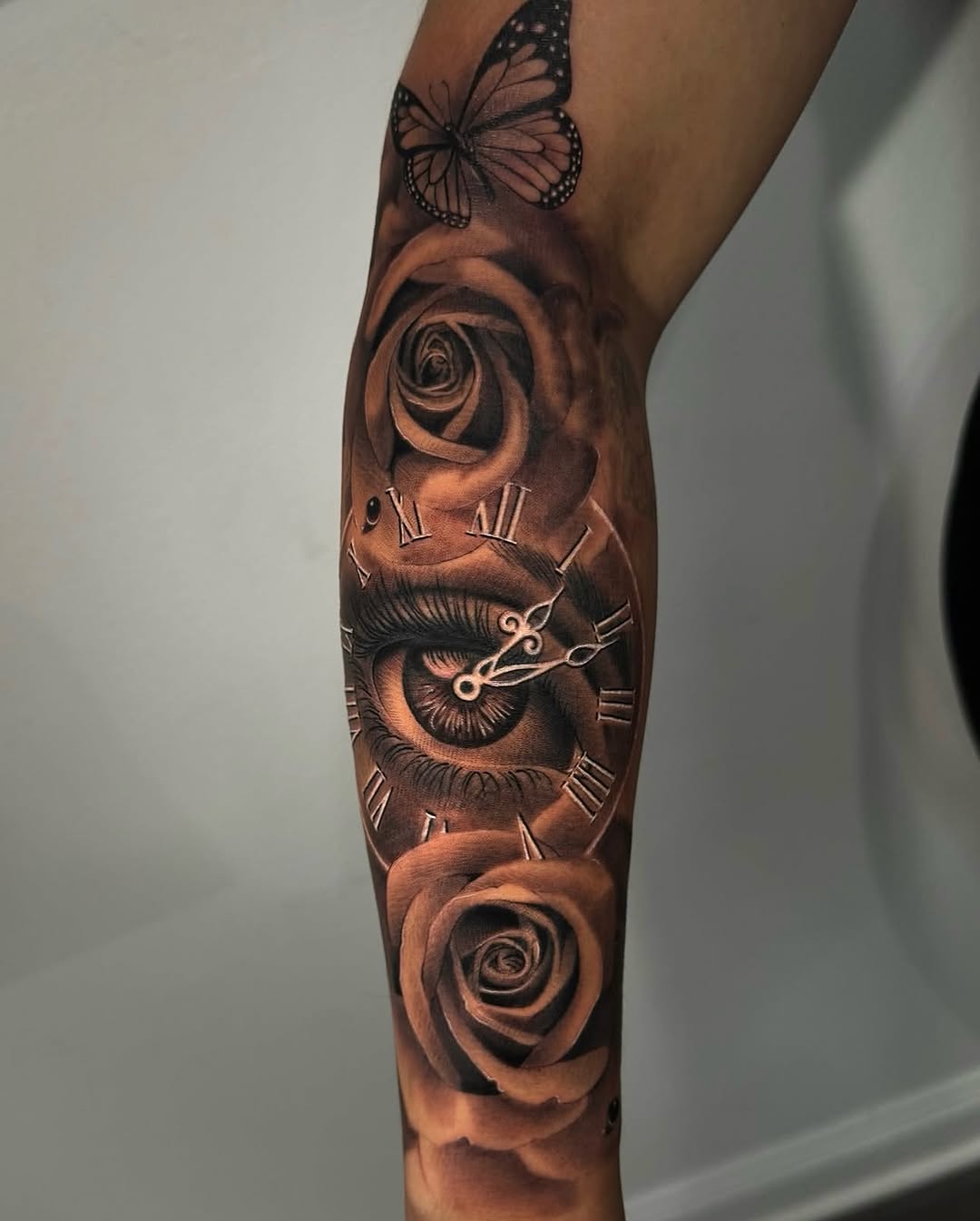 Eye, clock, roses, butterfly surrealism tattoo on the forearm by Gee Lagunas 🇲🇽, Springfield, Virginia