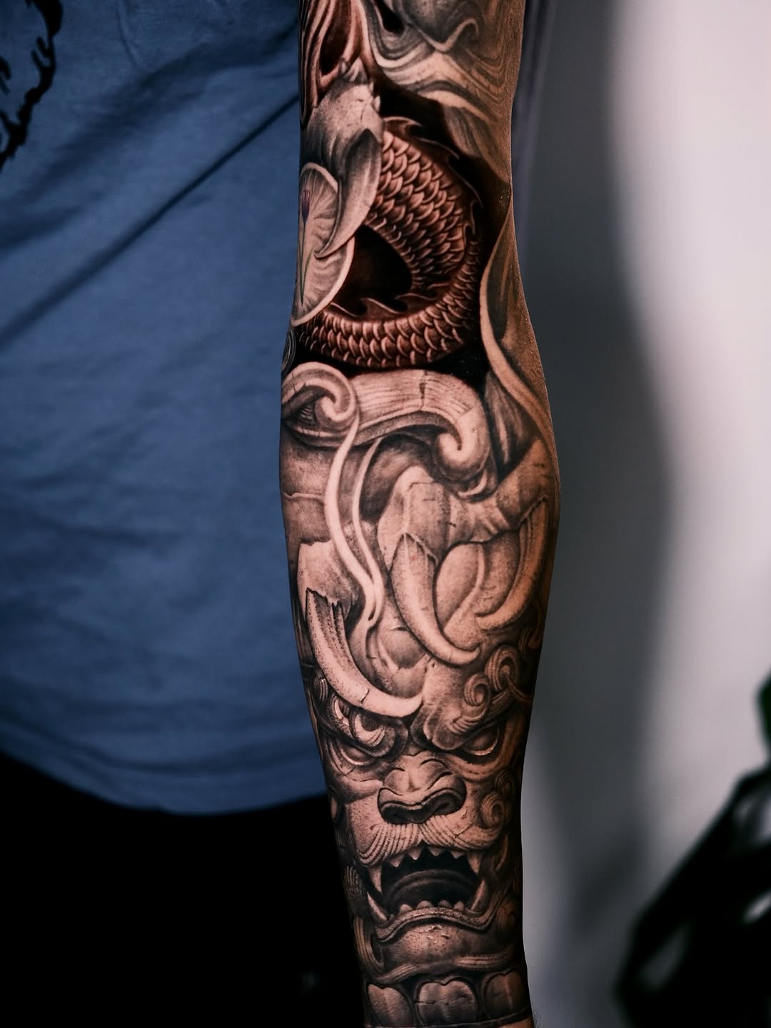 Dragon and foo dog Japanese tattoo on the forearm by Anh Nguyen