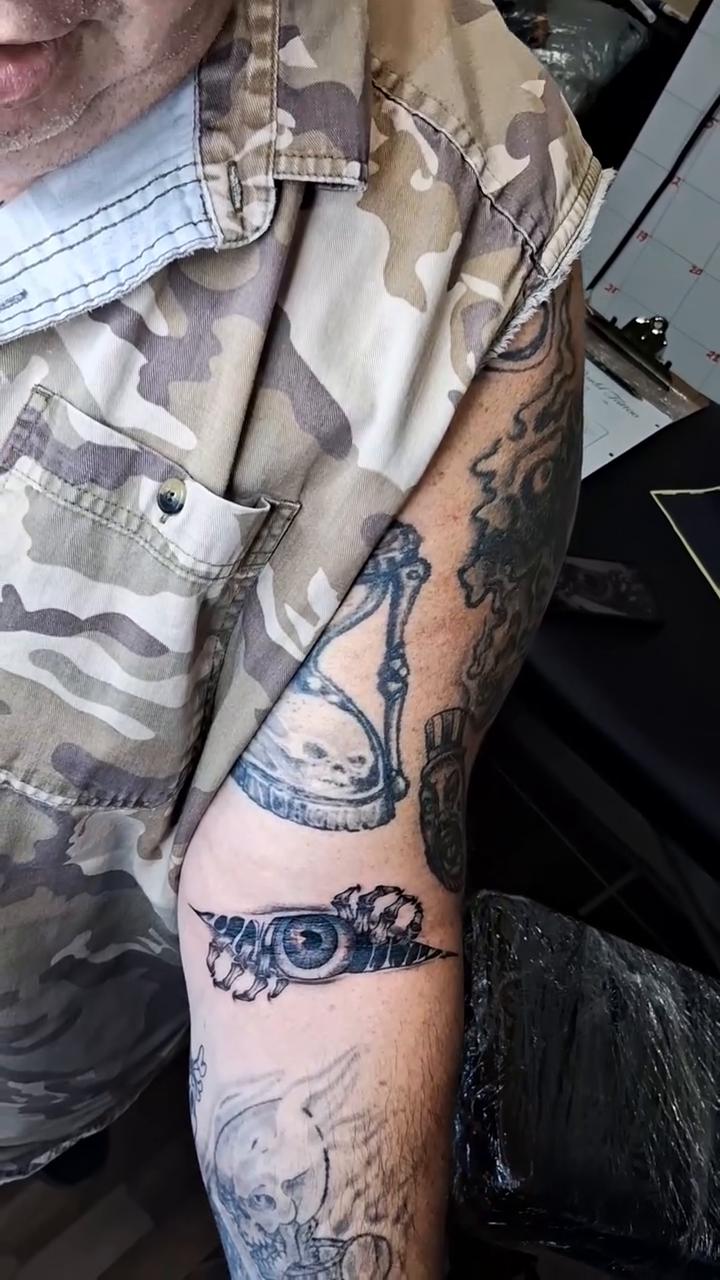 Hourglass and gears tattoo surrealism tattoo on the forearm by Tanya Tattoota