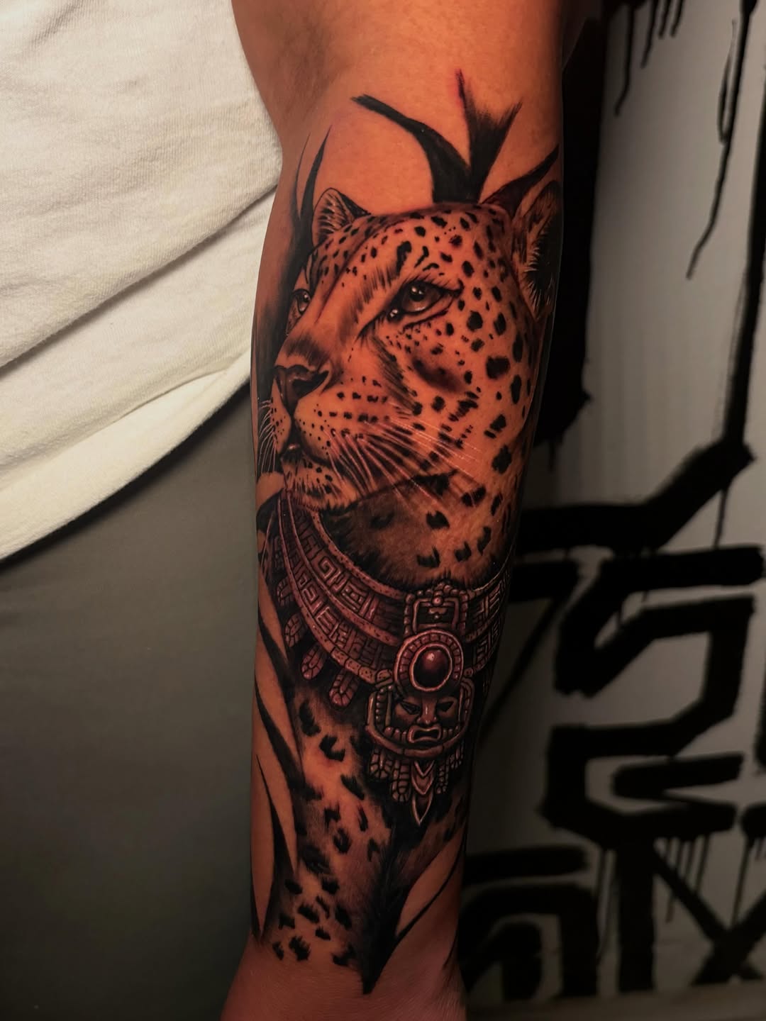 Leopard with ornate collar realism tattoo on the forearm by Lee