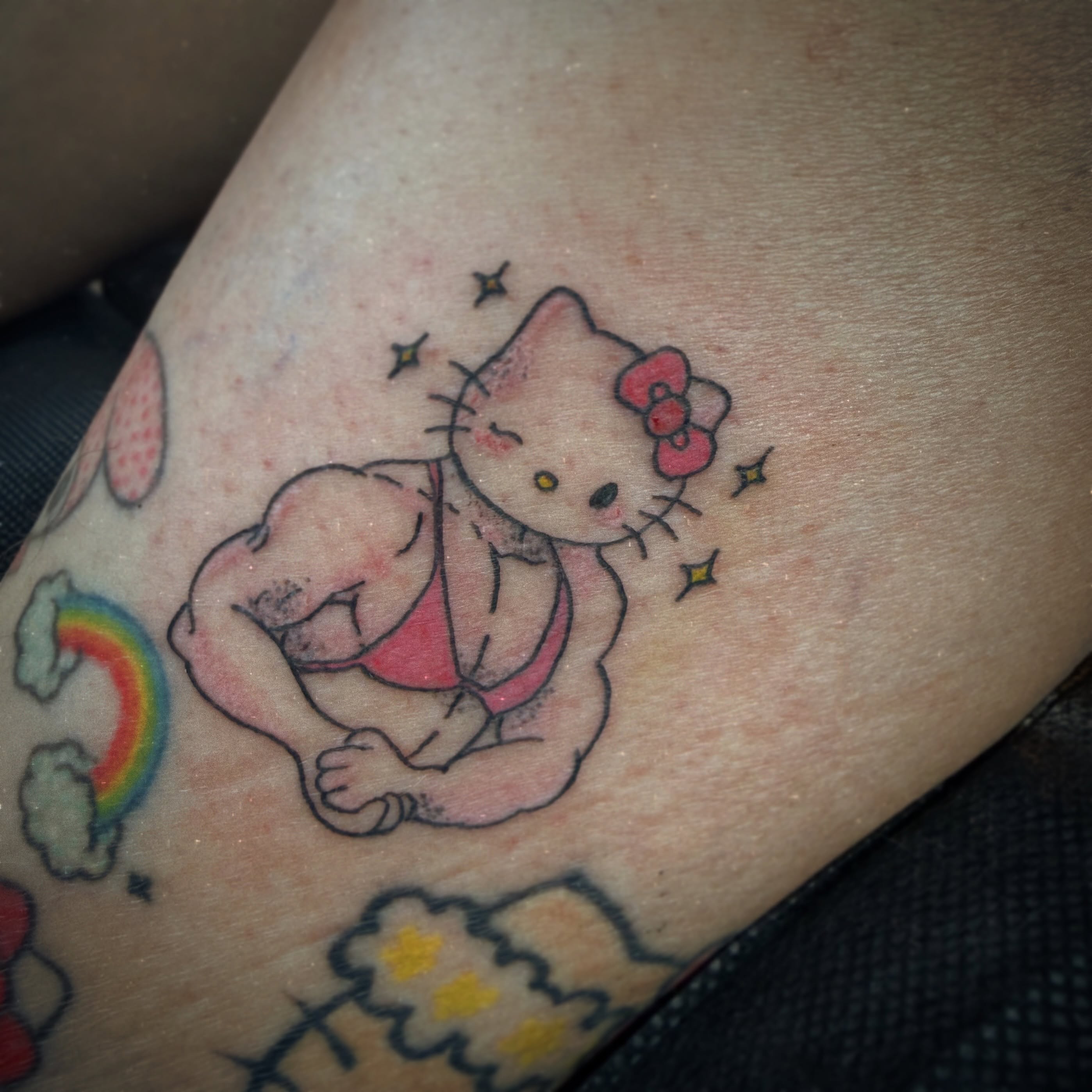 Hello Kitty and Winnie the Pooh new school tattoo on the forearm by Kraken ink Tattoo, San Francisco, California