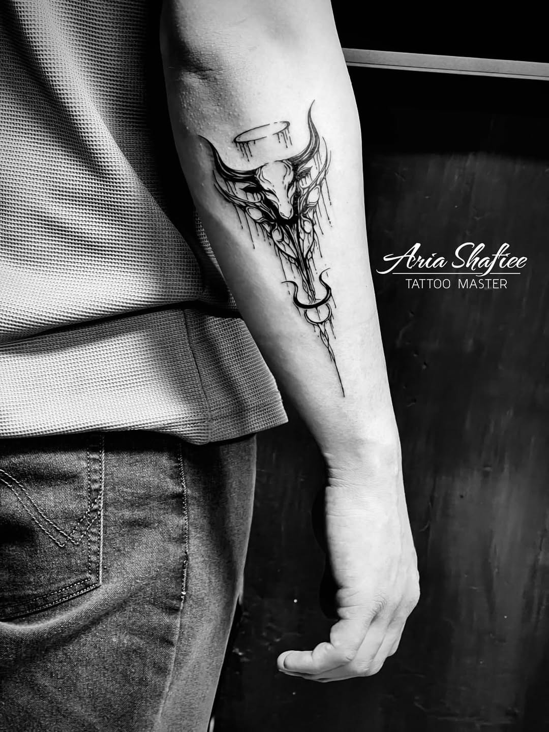 Stylized bull skull tribal tattoo on the forearm by Aria Shafiee