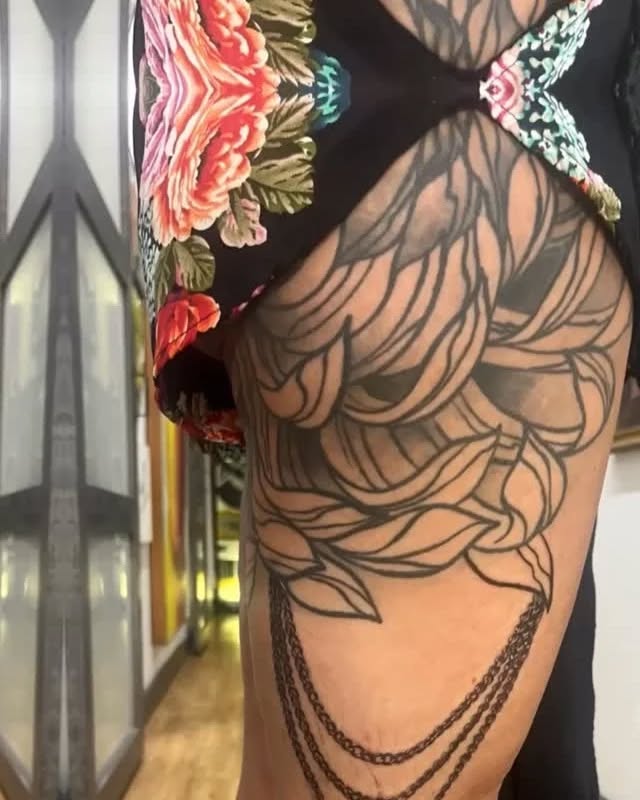 Floral and chain design tribal tattoo on the upper arm by Katelyn Bartoletti