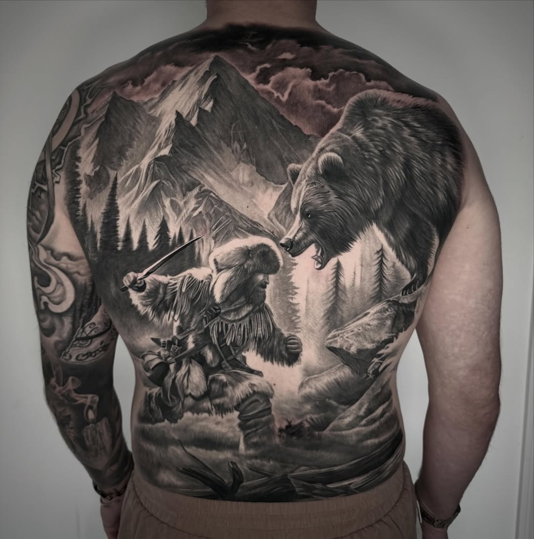 Mountain bear hunt realism tattoo on the back by TJ Schunemann