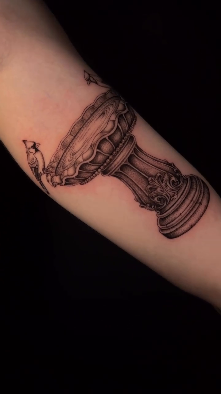 A decorative urn with birds dotwork tattoo on the forearm by Marianne