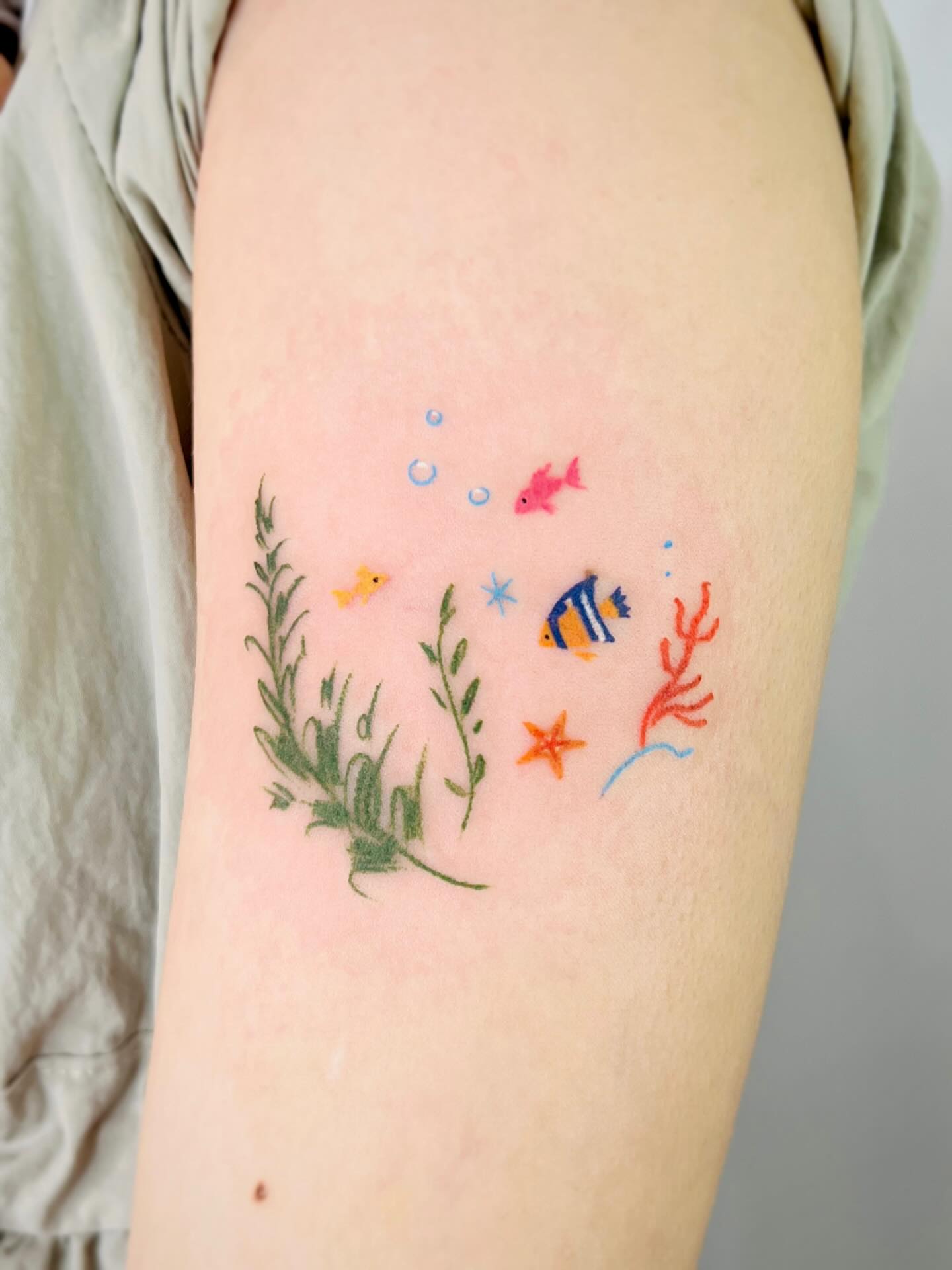 Underwater scene watercolor tattoo on the forearm by Purinn