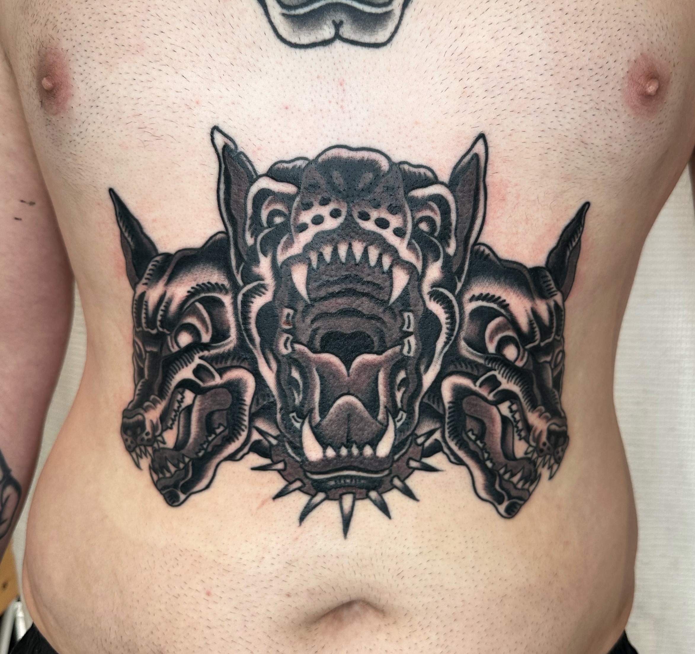 Three-headed dragon American traditional tattoo on the ribs by Brock Johnson