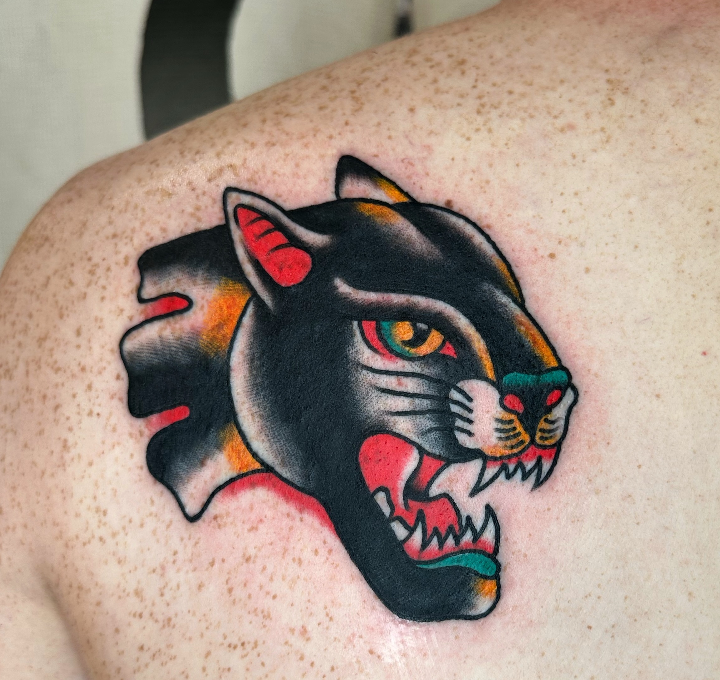 Panther American traditional tattoo on the shoulder by Brock Johnson