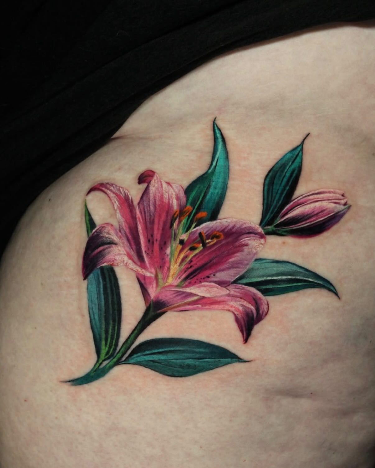 Lily realism tattoo on the shoulder by Eva Williams