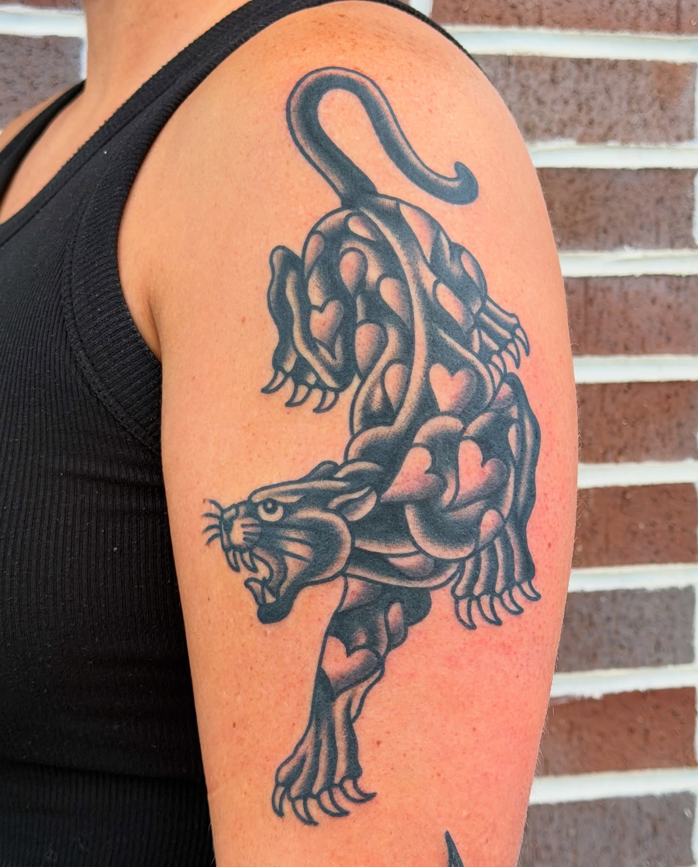 Panther black and grey tattoo on the shoulder by Nick Judkins Tattoo