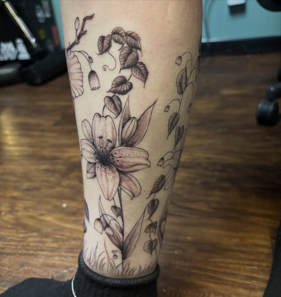 Lily flowers black and grey tattoo on the forearm by Terik Whittaker