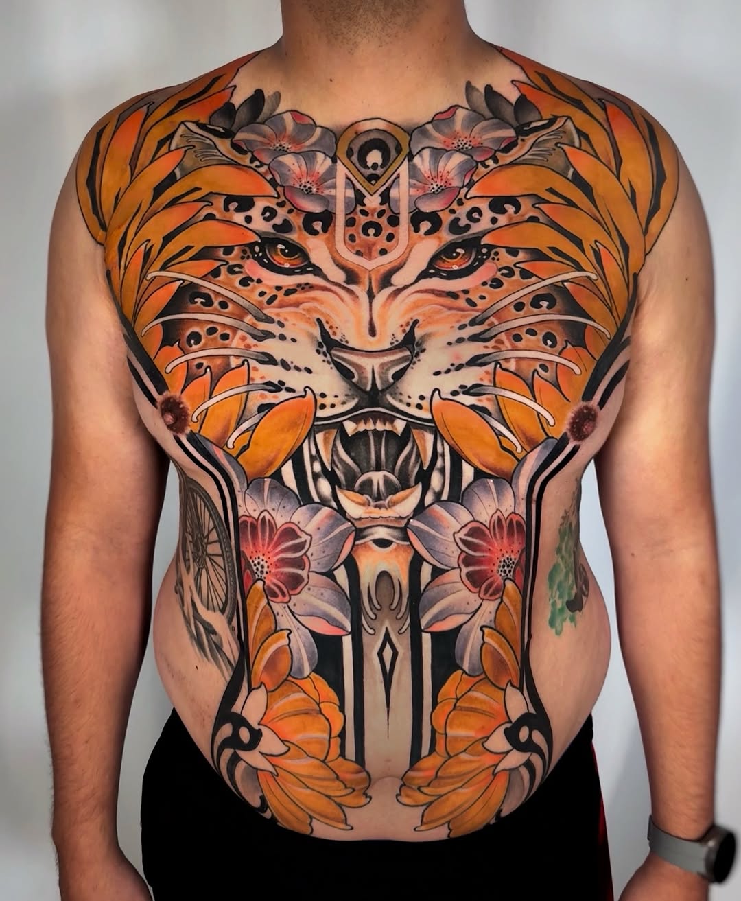 Tiger face with flowers realism tattoo on the chest by Aitor Arie, Roseville, California