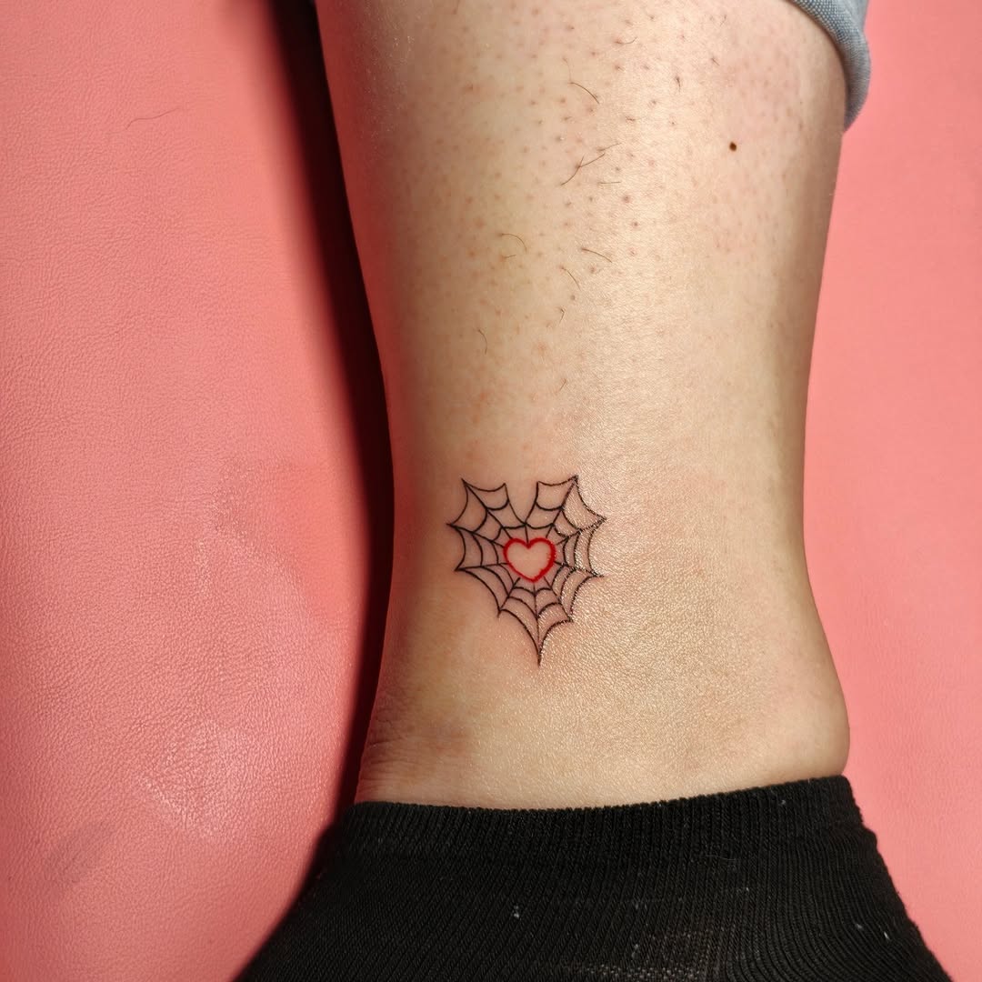 Spiderweb heart ornamental tattoo on the forearm by Dani Sandoval, Anaheim, California