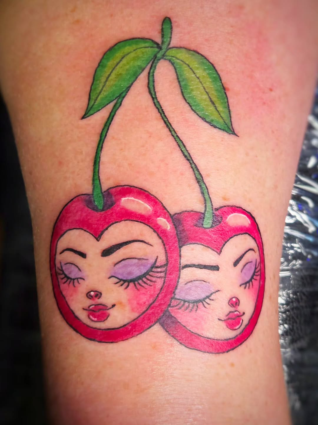 Cherries with faces neo-traditional tattoo on the forearm by Jam ⚡️🐉🖤