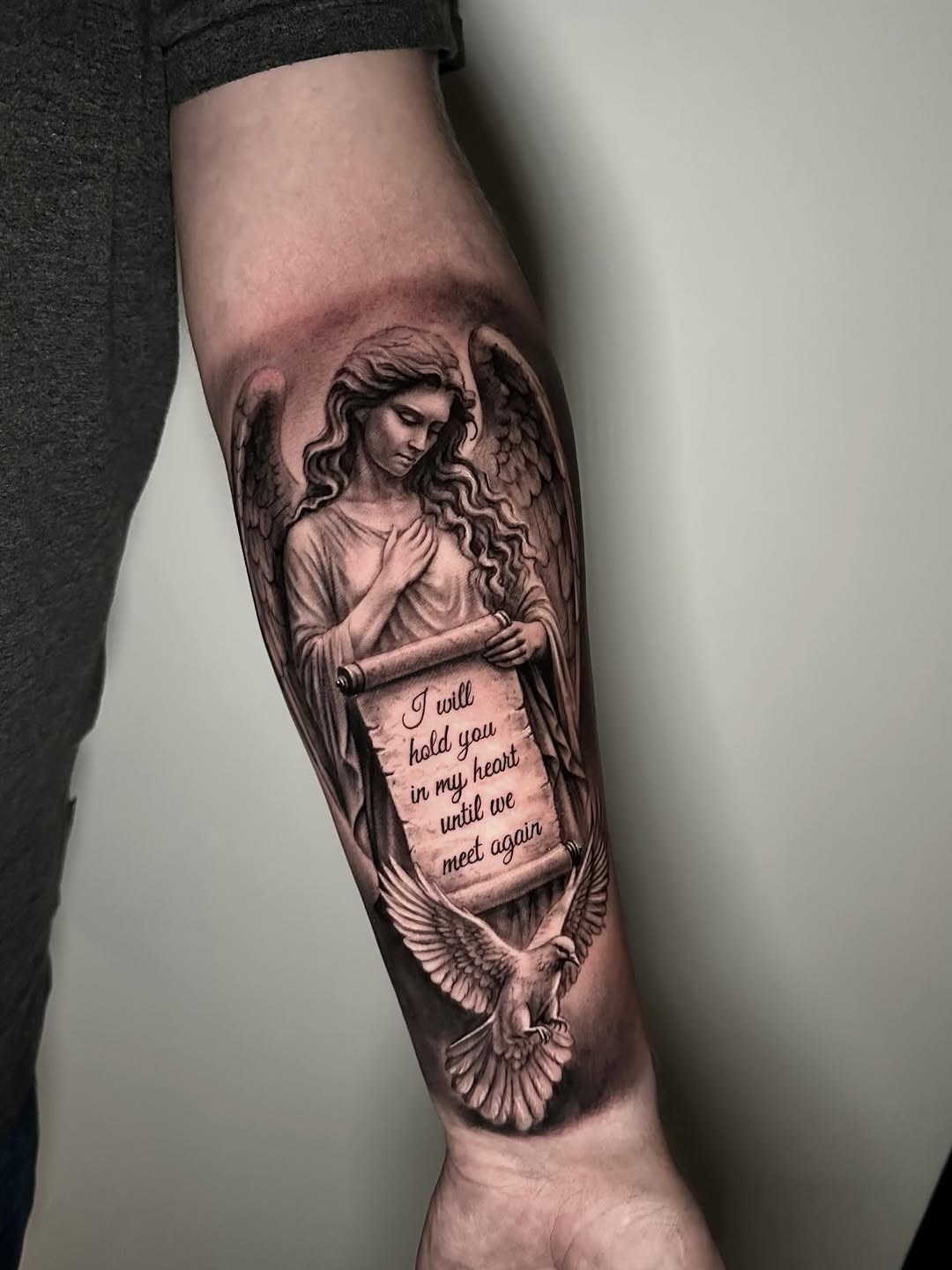 Angel holding scroll with dove realism tattoo on the forearm by Cipri Suciu