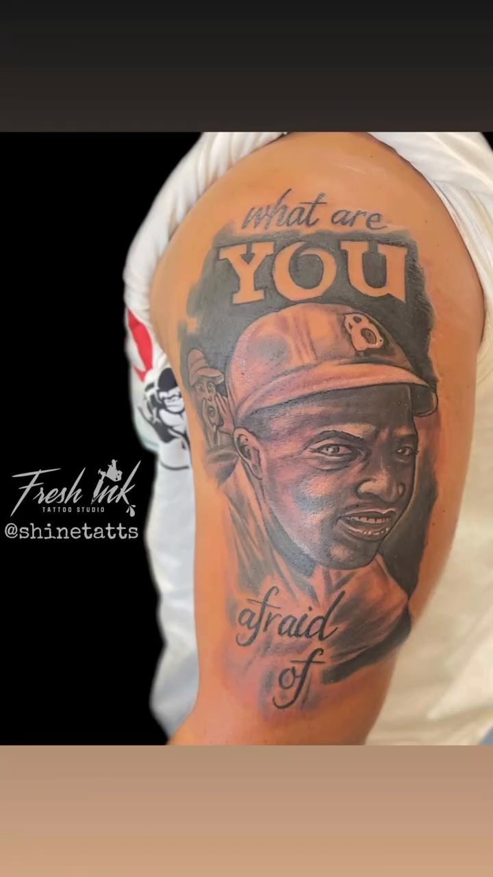 Portrait of a man with text tattoo on the upper arm by Shine Jefferson, Memphis, Tennessee