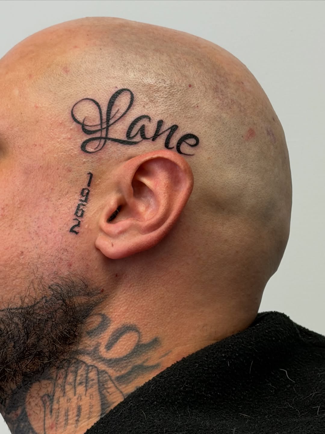 Name and numbers lettering tattoo on the head by Mandy Kaur
