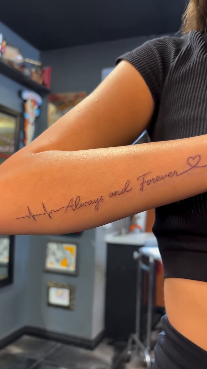 Lettering tattoo on the upper arm by alana khounmeuang