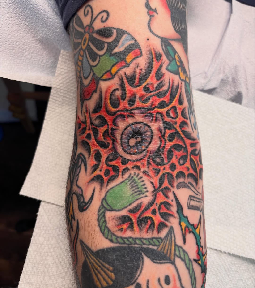 Eye and flame American traditional tattoo on the forearm by Steve Reid