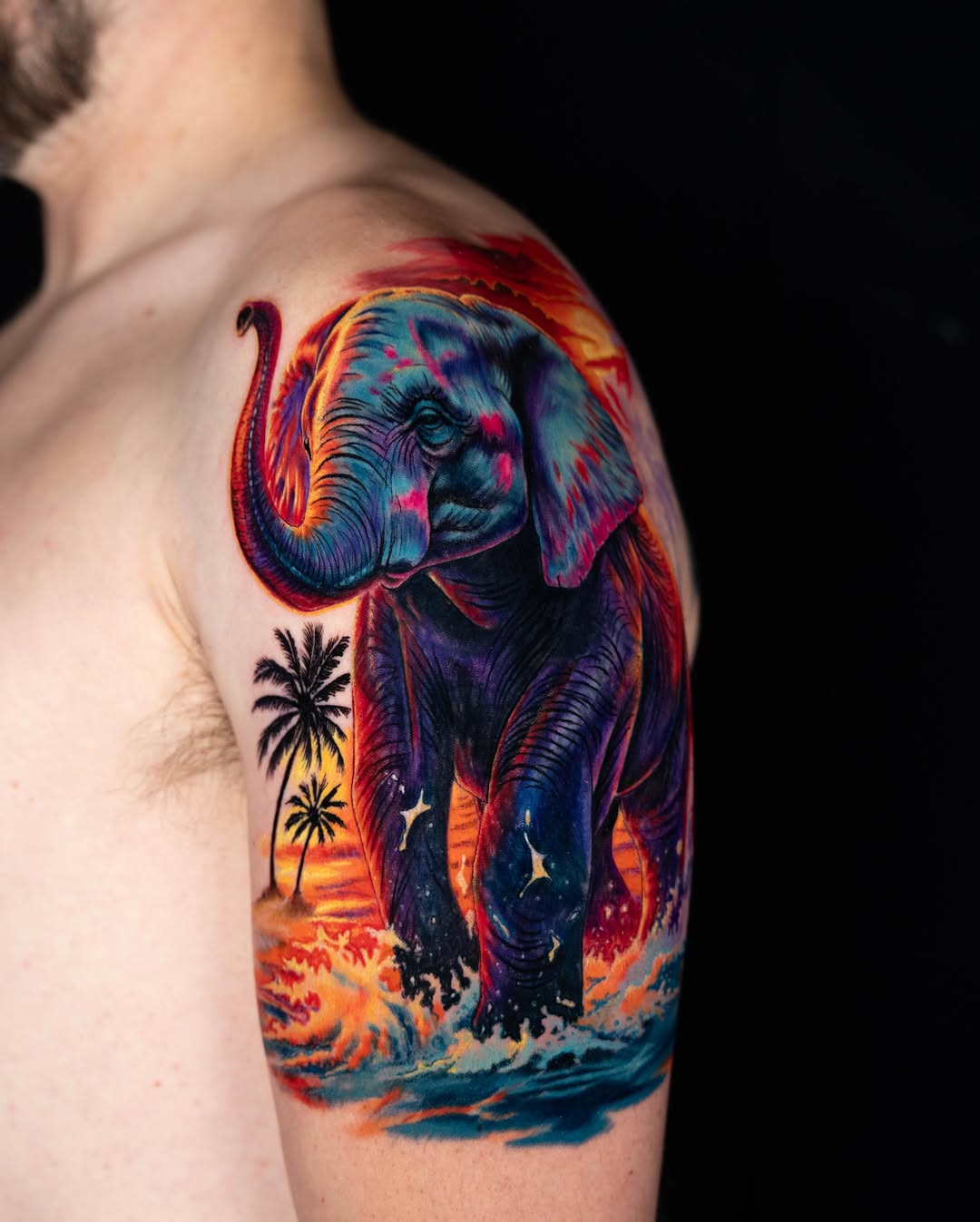 Elephant on beach at sunset watercolor tattoo on the upper arm by Keebs