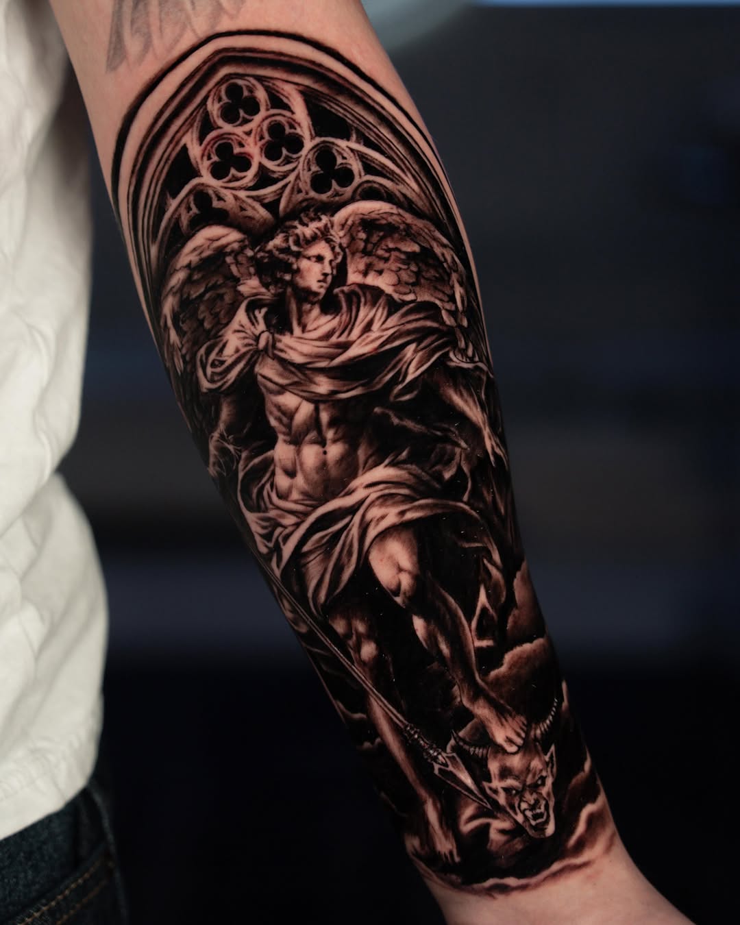 Angel fighting demon realism tattoo on the forearm by Keebs