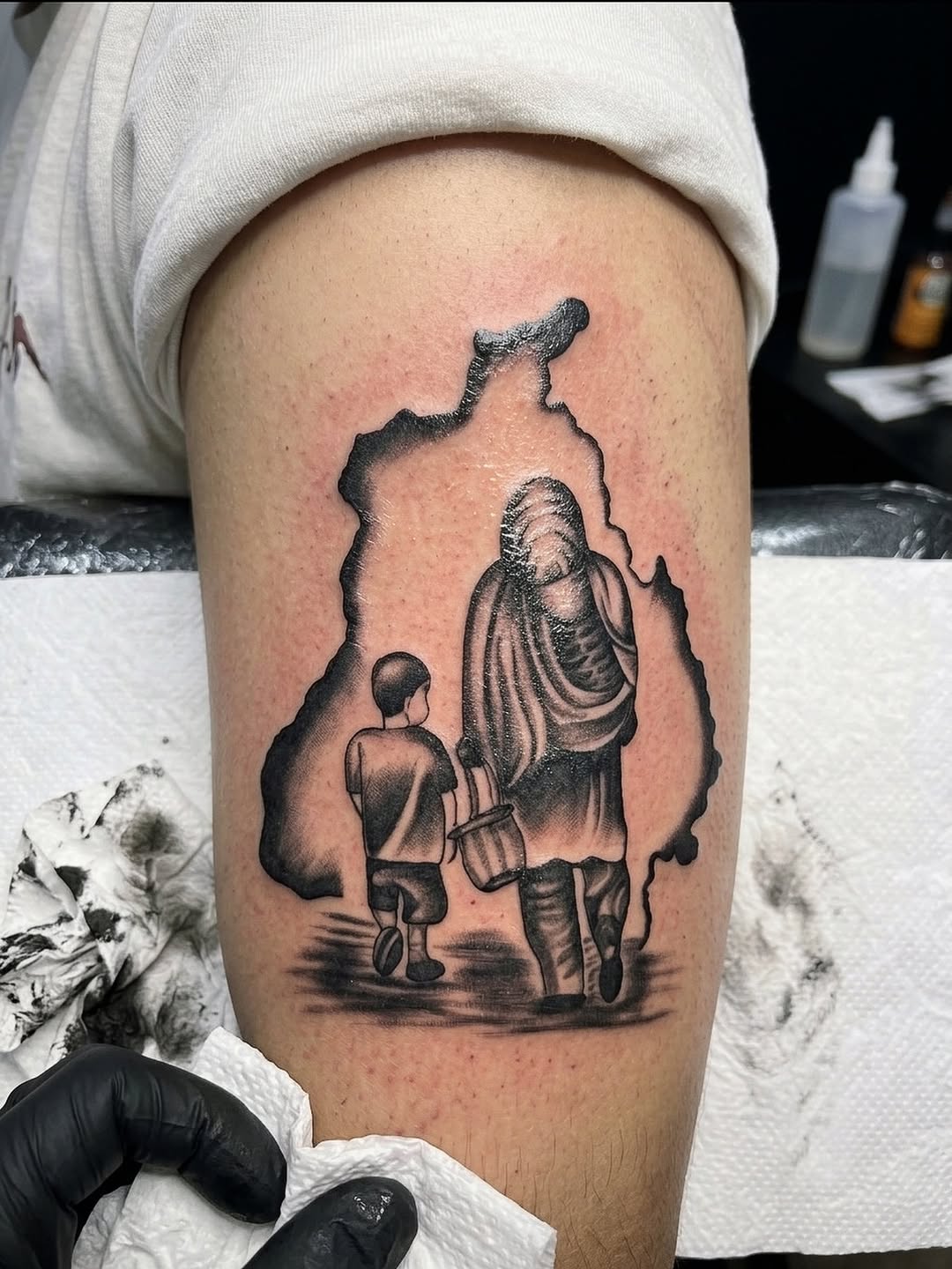 Map outline with figures fine line tattoo on the thigh by I N K S L A y e R