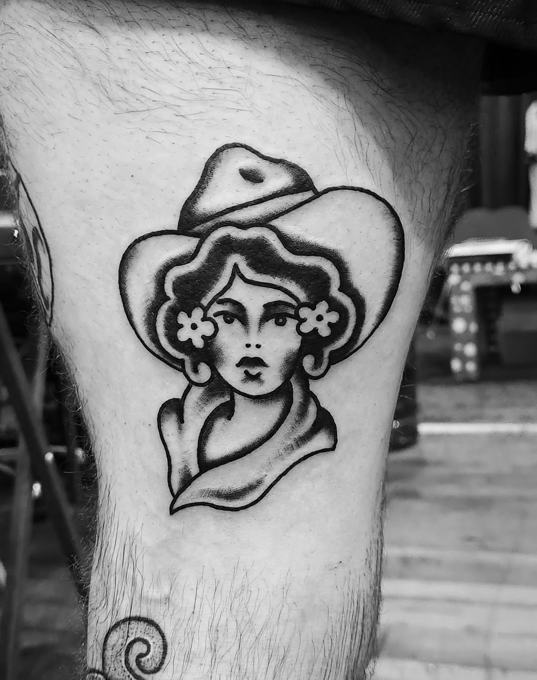 Woman with hat and flowers realism tattoo on the thigh by Douglas Grady