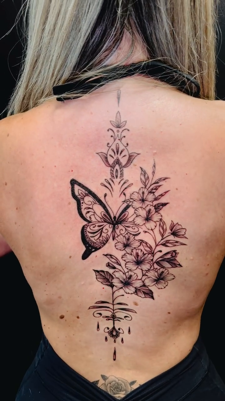 Butterfly and floral spinal tattoo fine line tattoo on the back by Erik Pagtakhan